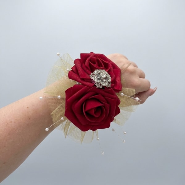 Red rose wrist corsage with pearl accents and gold tulle