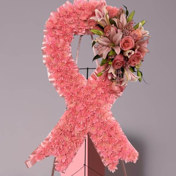 Pink floral standing ribbon wreath with a rose and lily cluster
