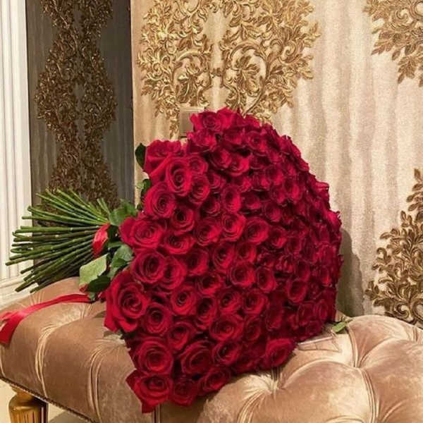Large bouquet of red roses with long stems tied together
