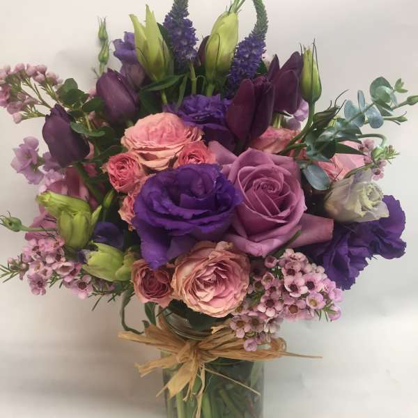 Purple and pink mixed bouquet in a glass vase