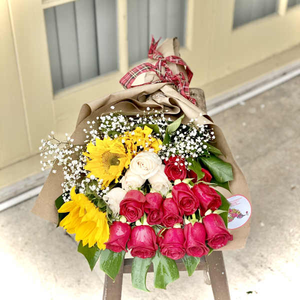 Bouquet of red, white, and yellow roses with sunflowers