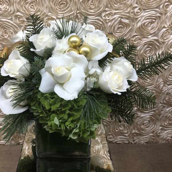 White roses and green hydrangeas in a dark vase with gold ornaments