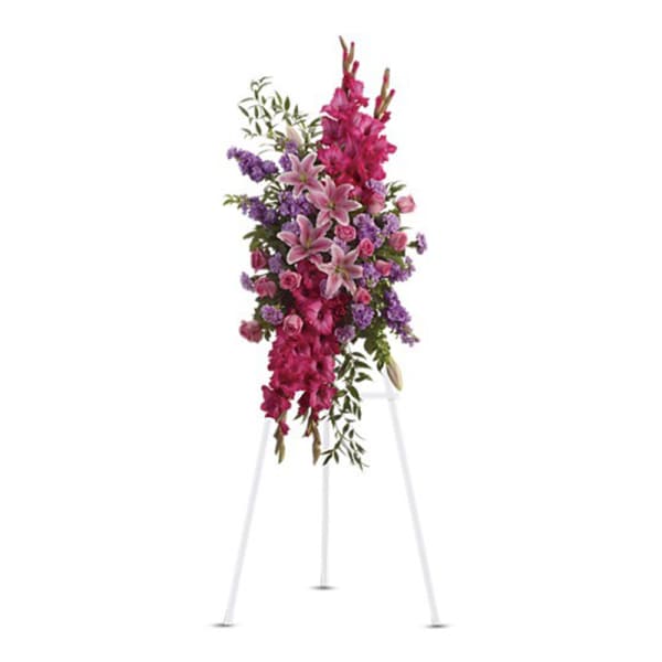 Tall pink and purple floral spray on a white stand