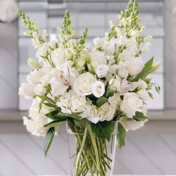 White floral arrangement in a clear glass vase