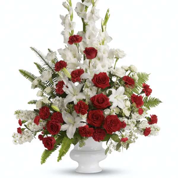 Red roses and white lilies in a white pedestal vase