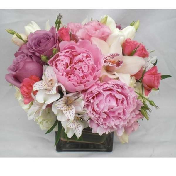 Pink and white bouquet in a square glass vase