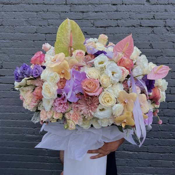 Large pastel flower arrangement in a white hat box