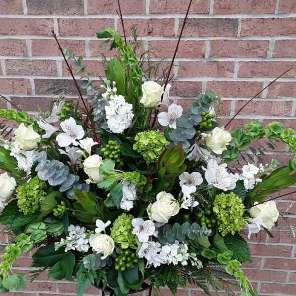 Large white and green floral spray with roses and hydrangeas