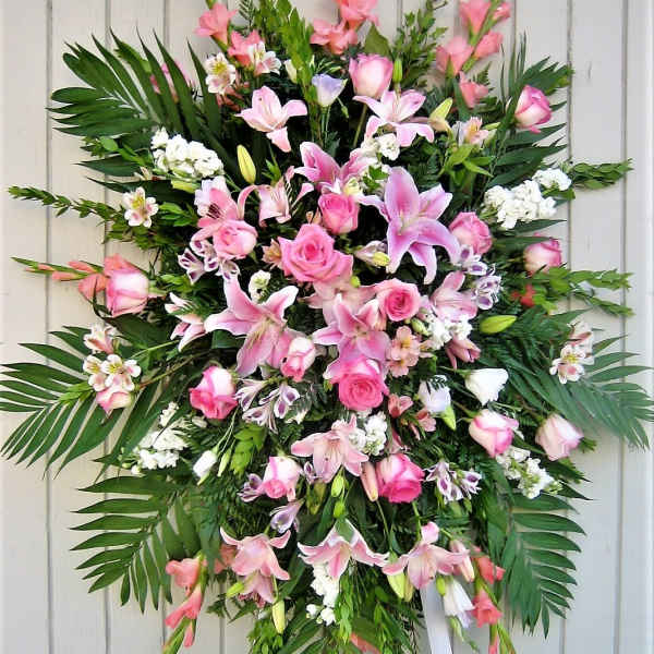 Large pink floral standing spray with lilies and roses