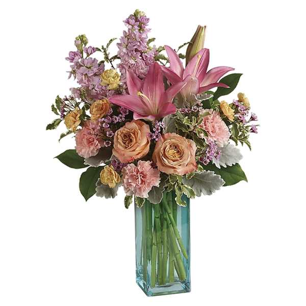 Pink lilies and peach roses in a blue glass vase