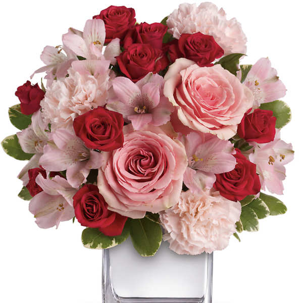 Pink and red rose bouquet in a clear glass vase