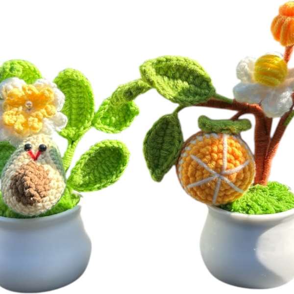 Two crocheted potted plants with flowers and fruit shapes