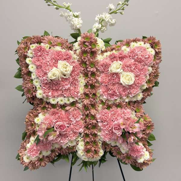 Butterfly-shaped floral standing spray in pink and white