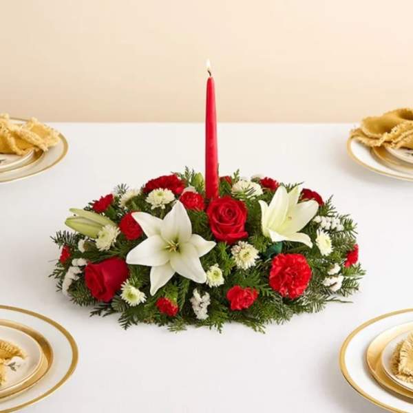 Red and white floral centerpiece with a tall red candle