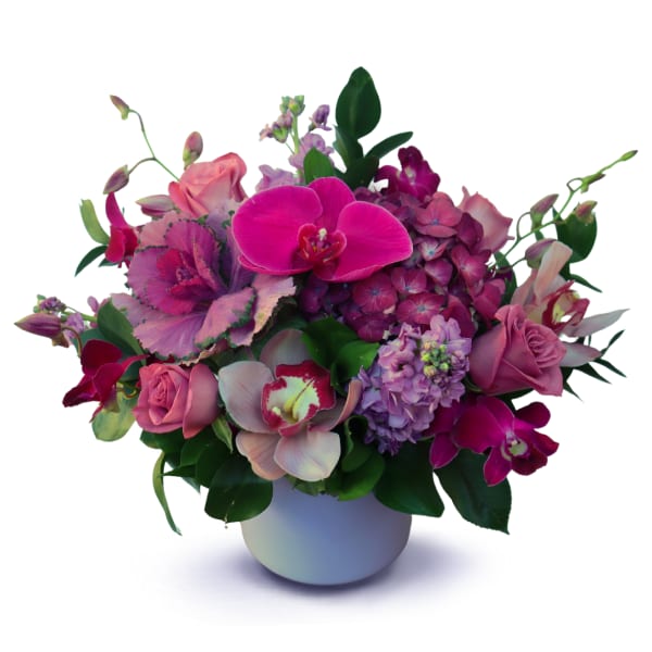 Pink and purple floral arrangement in a white vase