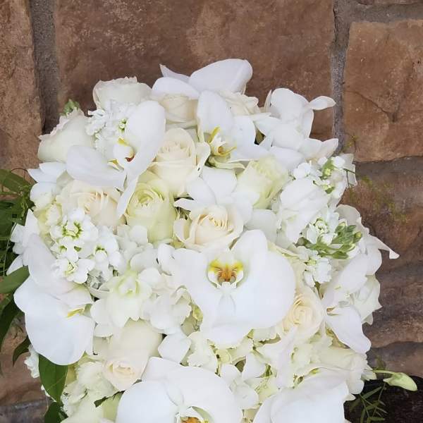 White floral bouquet with orchids and roses