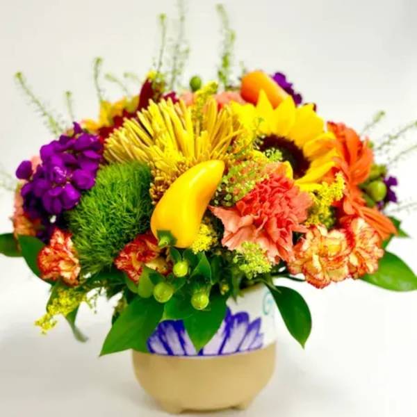 Bright mixed flower arrangement in a decorative vase