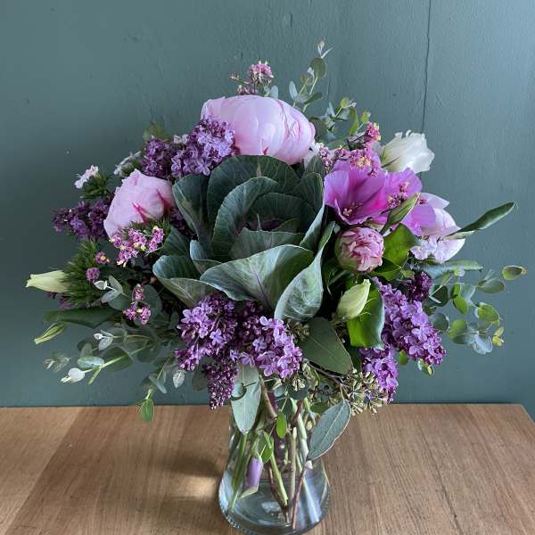 Pink and purple mixed bouquet in a clear glass vase