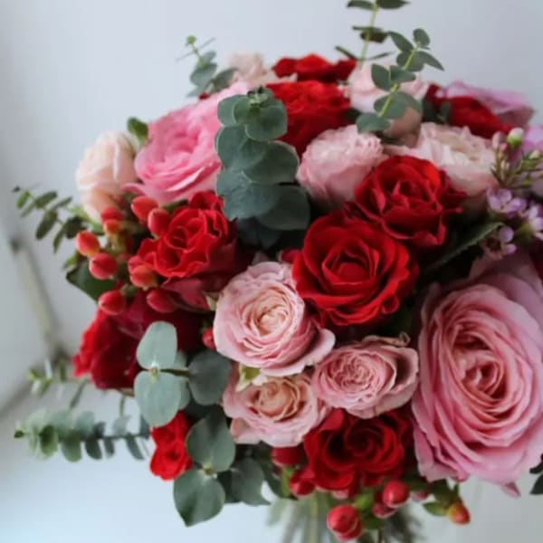 Bouquet of red and pink roses with eucalyptus