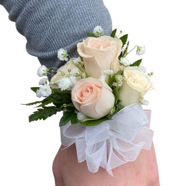 Wrist corsage with pale roses and white ribbon