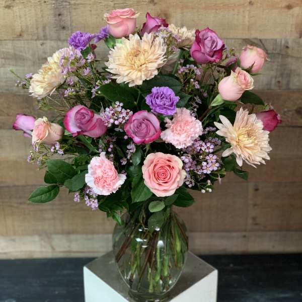 Pink and cream mixed bouquet in a clear glass vase