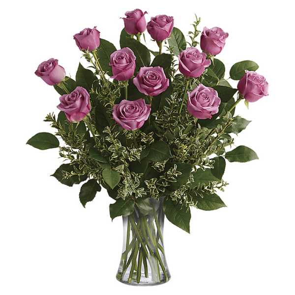 Pink roses arranged in a clear glass vase