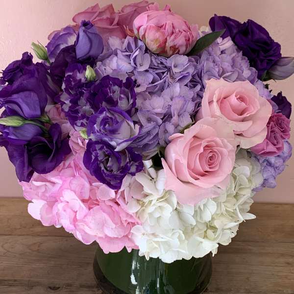 Pink, purple, and white flower bouquet in a glass vase