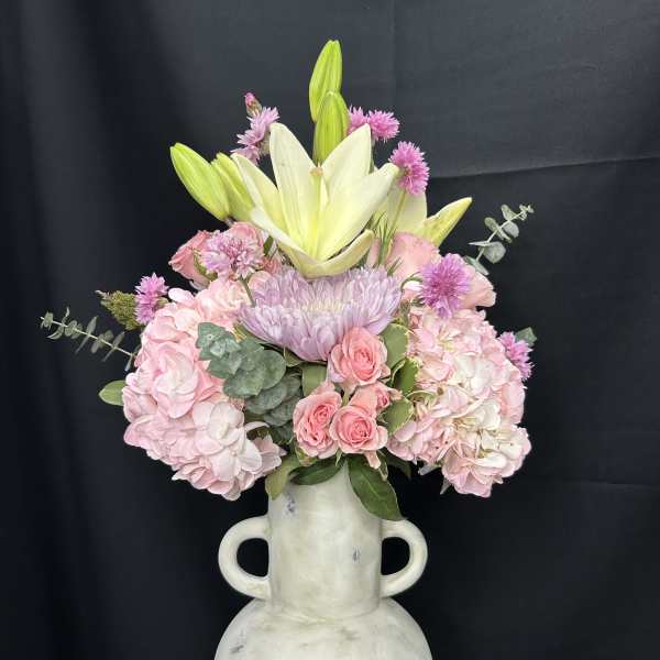 Pink and white floral arrangement in a white vase