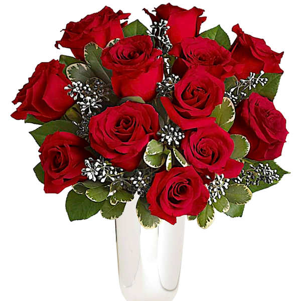 Red roses arranged in a clear glass vase