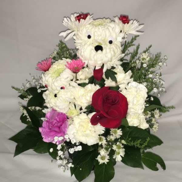 Playful dog-shaped flower arrangement in white blooms with a red rose and pink accents