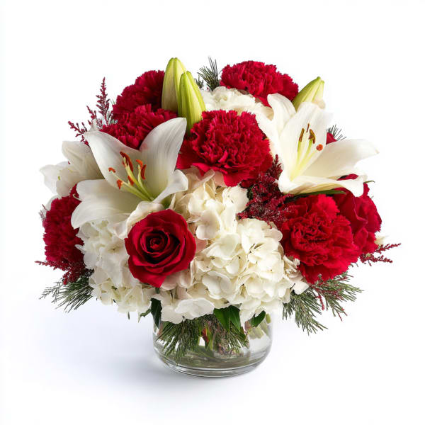 Red and white bouquet with lilies, roses, carnations, and hydrangeas in a glass vase