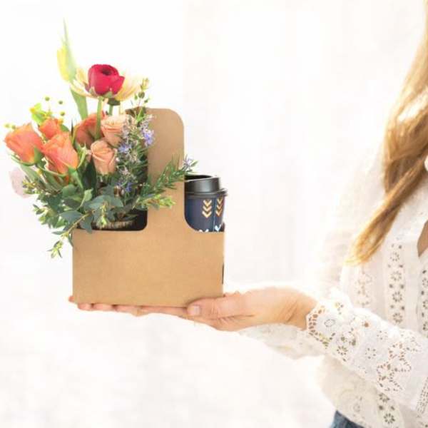 Mixed bouquet in a cardboard gift box with a travel cup