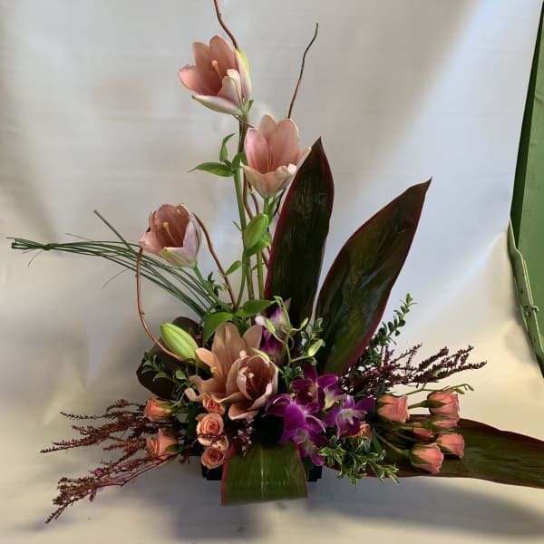Tall floral arrangement with pink blooms and purple orchids