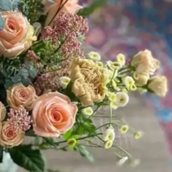 Bouquet of pale pink roses and cream flowers with small filler blooms