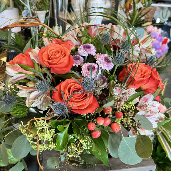 Bouquet of orange roses with pink alstroemeria and blue thistle