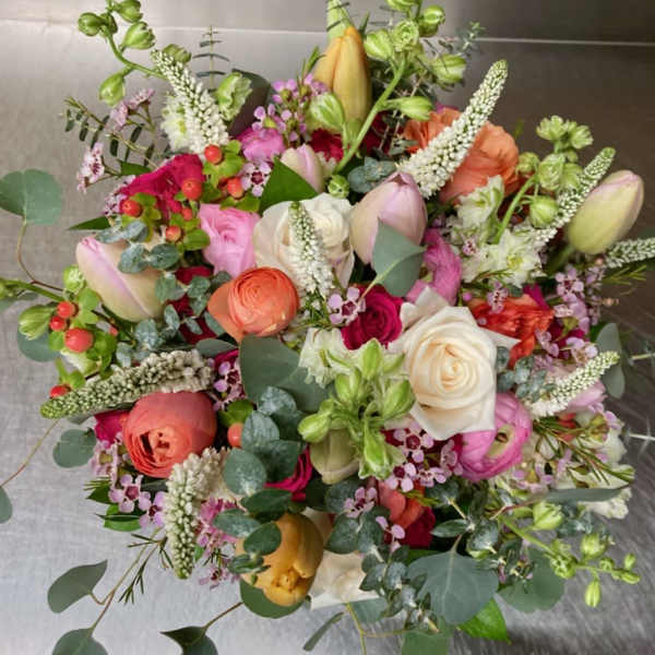 Mixed bouquet of roses, tulips, and ranunculus in pink, white, and peach