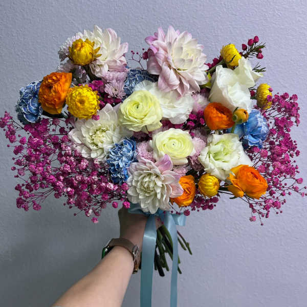 Colorful bouquet of mixed flowers with a blue ribbon tie