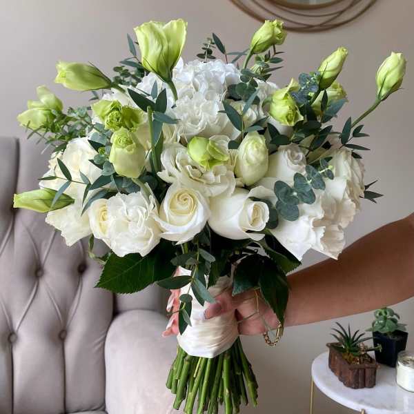 Bouquet of white roses and pale green lisianthus with eucalyptus
