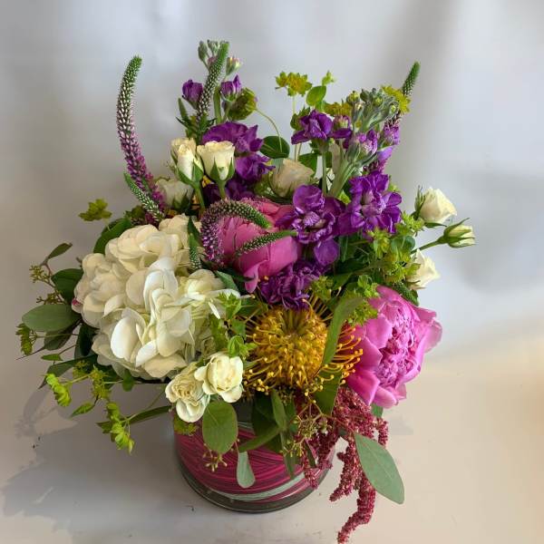 Mixed bouquet in a glass vase with white, pink, and purple flowers