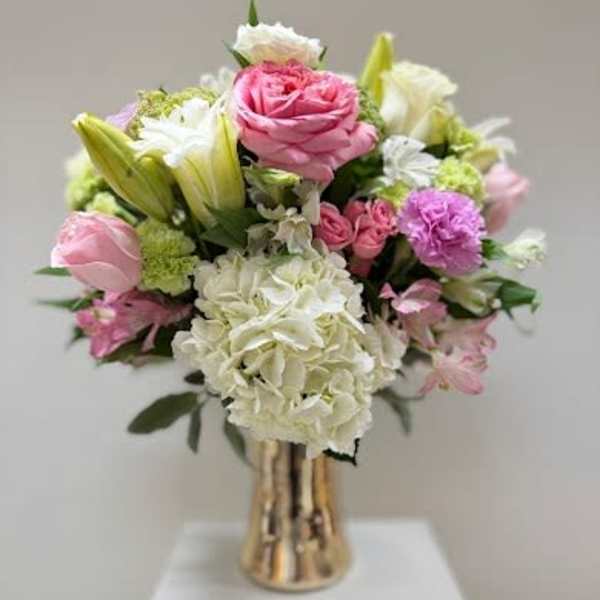Pink and white bouquet in a gold vase