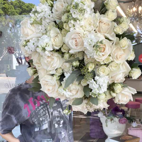 Large bouquet of white roses and white flowers with greenery