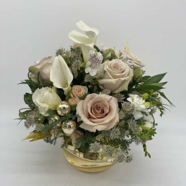 Low gold bowl arrangement with blush roses, white calla lilies, and mixed white flowers with gold accents.