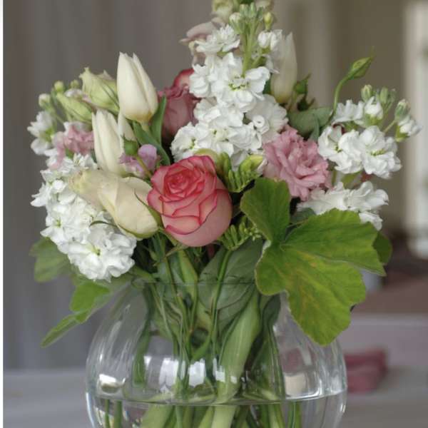 Bouquet of pink and white flowers in a clear glass vase