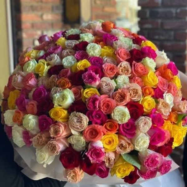 Large bouquet of multicolored roses wrapped in paper