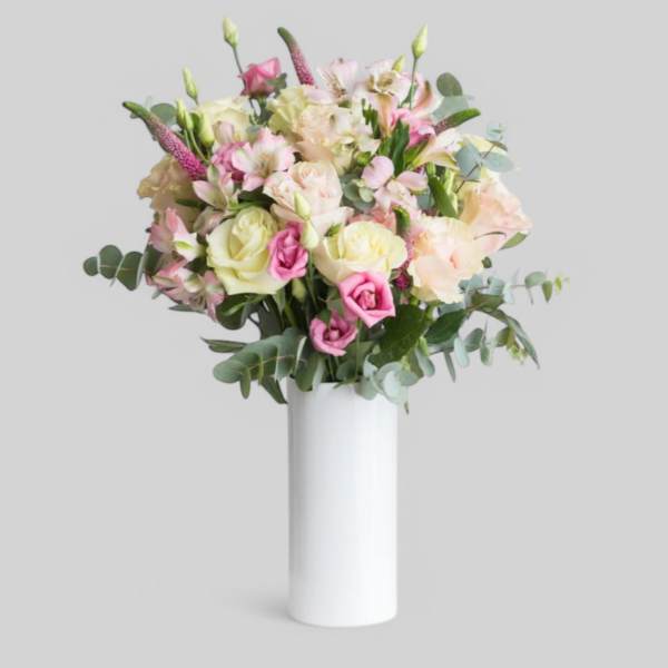 Pink and cream bouquet in a white vase