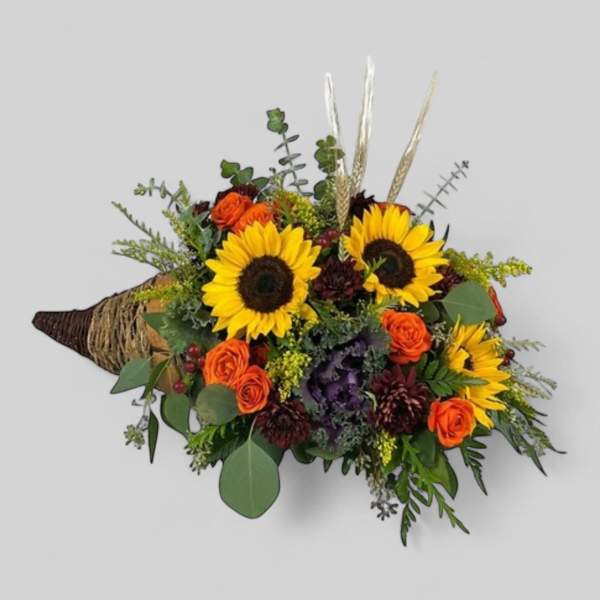 Bouquet with sunflowers and orange roses wrapped in burlap
