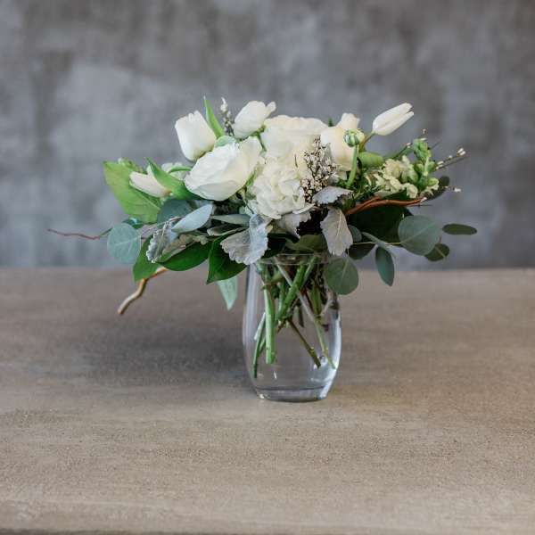 White floral arrangement in a clear glass vase