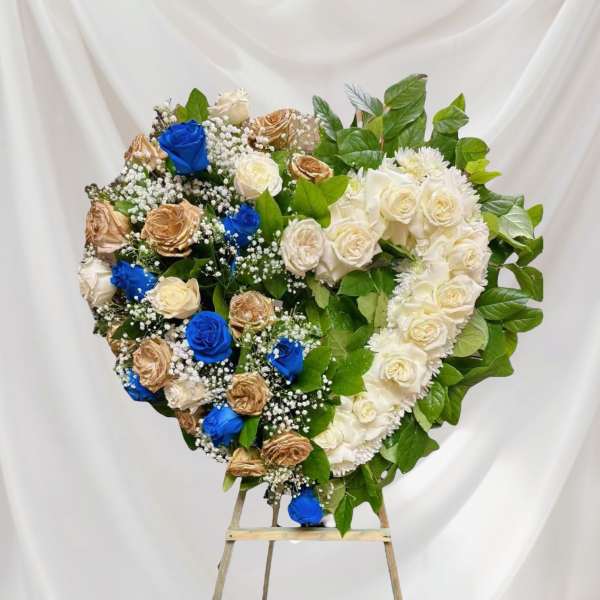 Heart-shaped floral wreath of roses on an easel