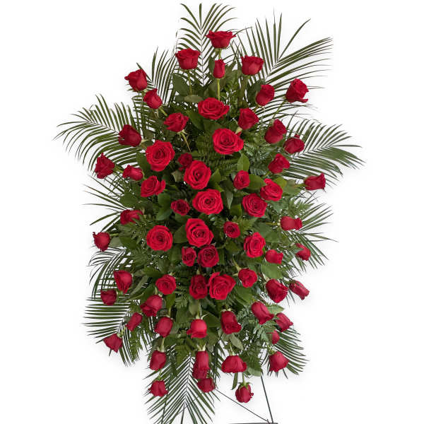 Standing spray of red roses with palm fronds on a wire easel