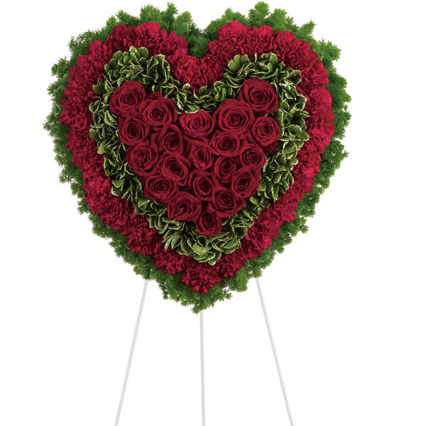 Heart-shaped standing floral tribute with red roses and carnations